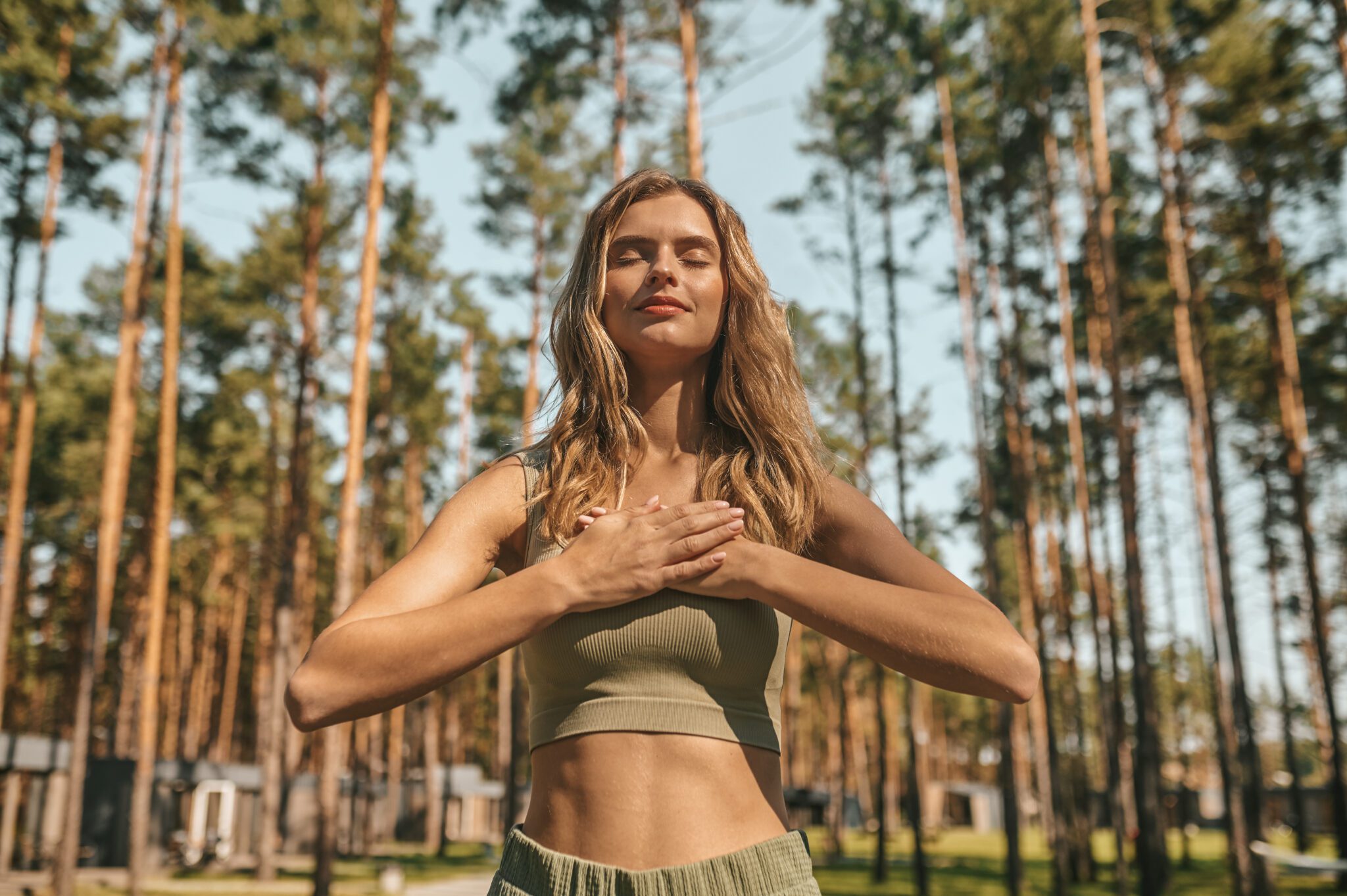 cute blonde woman practising yoga outside looking relaxed 2048x1363